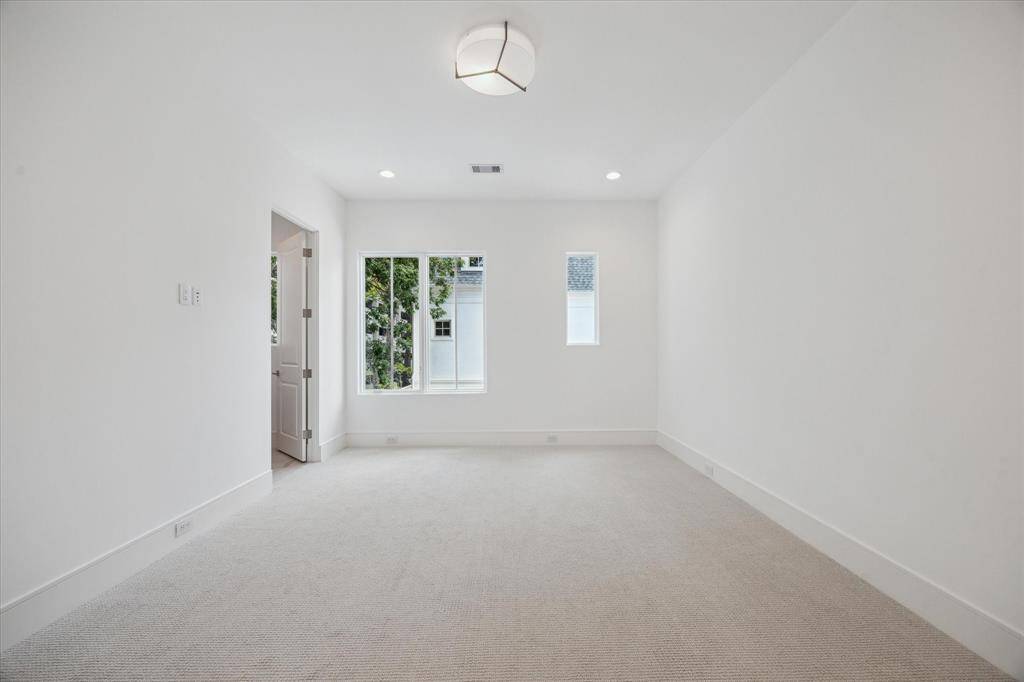 Second-floor bedroom receives ample natural light and features a  Dreamweaver Pinpoint high-performance carpet and AFX LumaFuse light fixture with  laminated fabric/acrylic shade.
