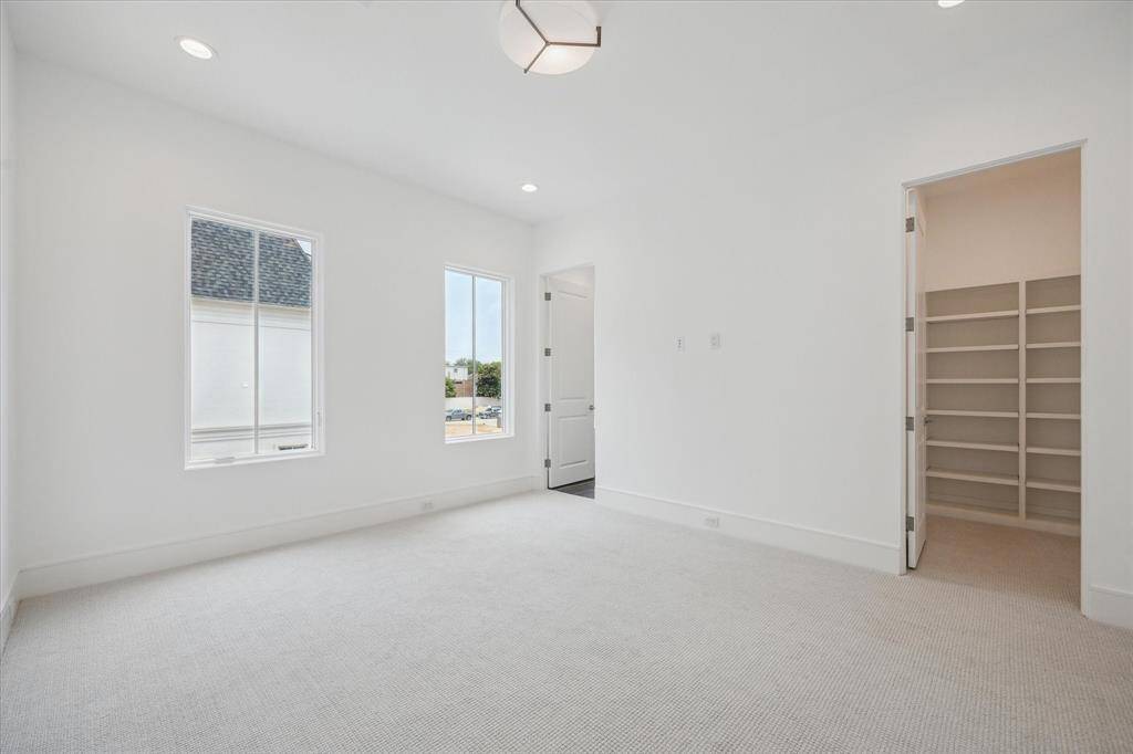 The final second-floor bedroom features Dreamweaver Pinpoint high-performance carpet and spacious walk-in closet.