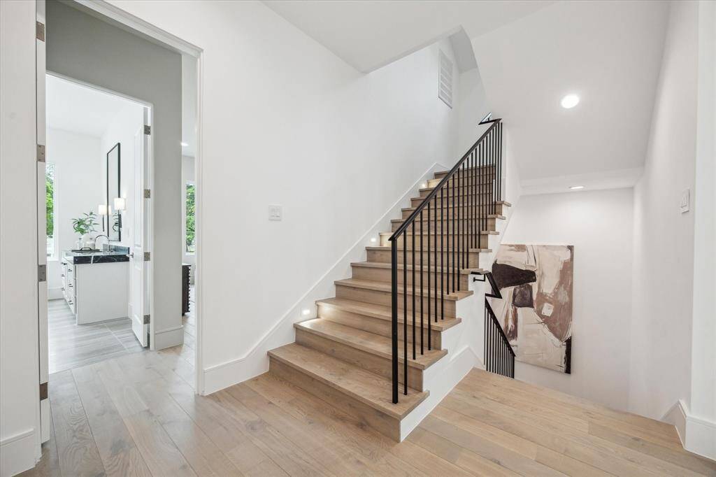 Second floor landing area with stairs and elevator shaft leading to third floor gameroom and final bedroom with en-suite bath.