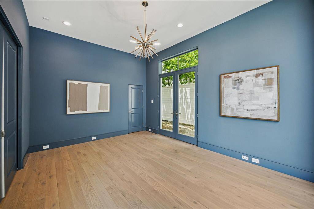 Designer light fixture, spacious closet, and pocket doors complete this spacious room.