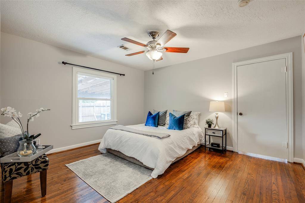 Primary Bedroom to the back of the home, hardwood floors, ensuite bathroom