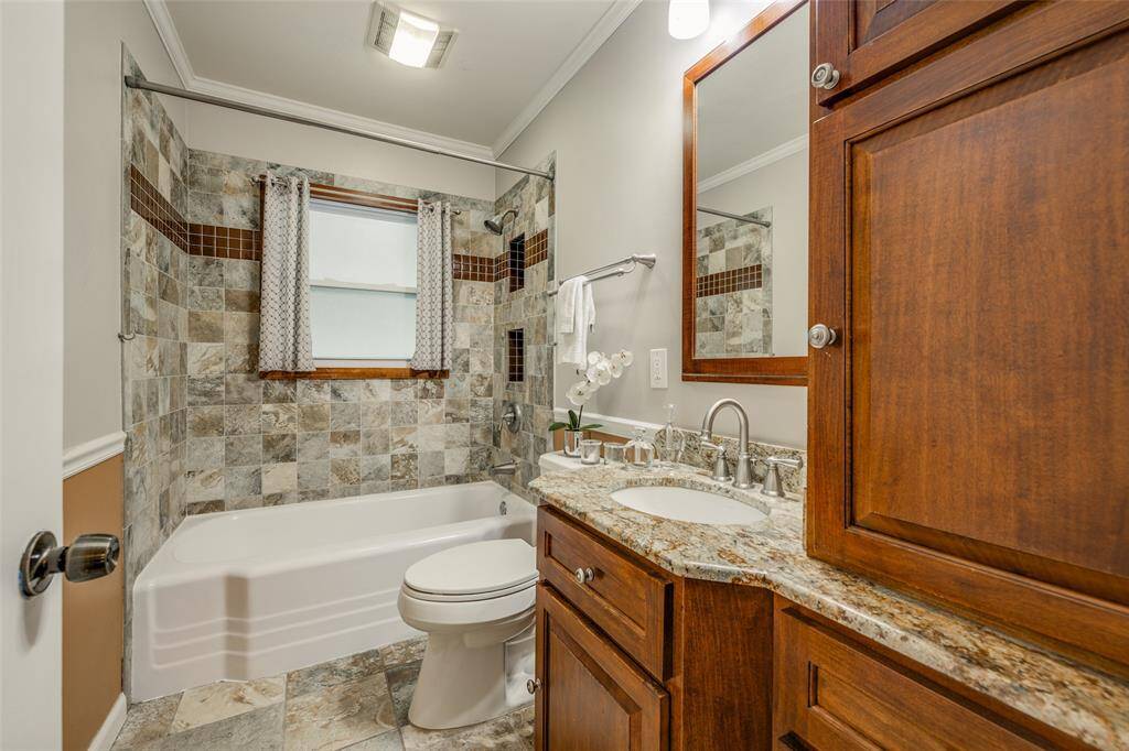 Bathroom 2 - remodeled with granite counter, bath, travertine tile