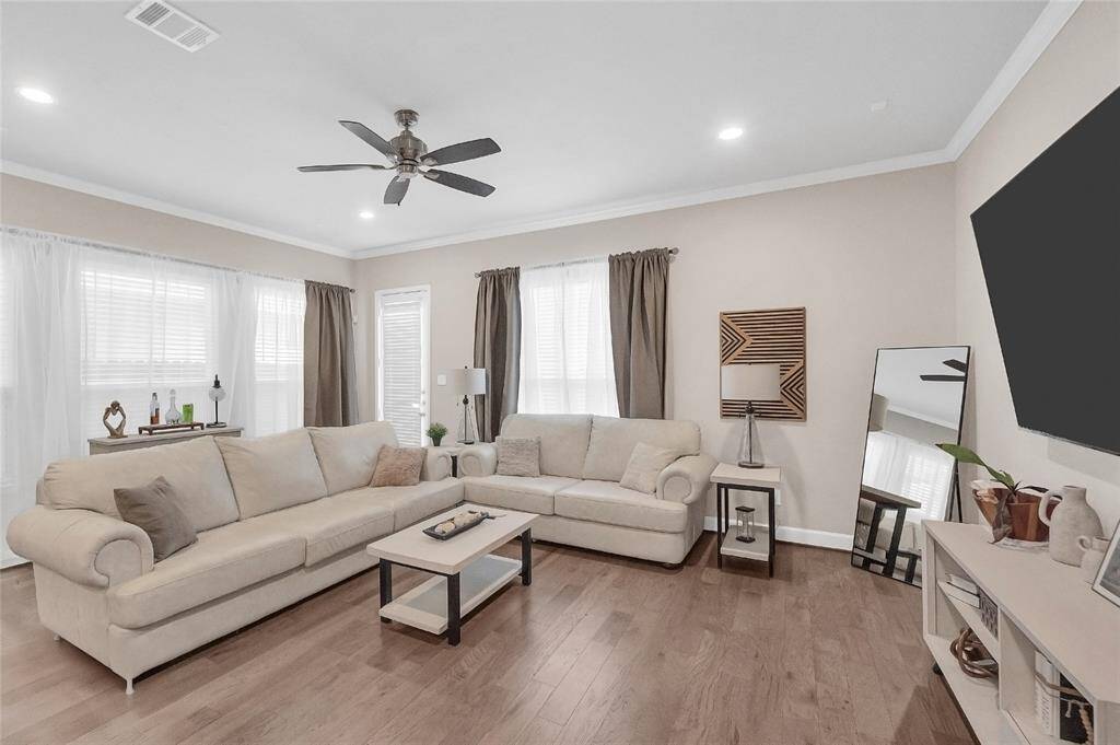 Large windows allow for an abundance of natural light to flow through the home. Notice the nice hardwood floors throughout the first floor.