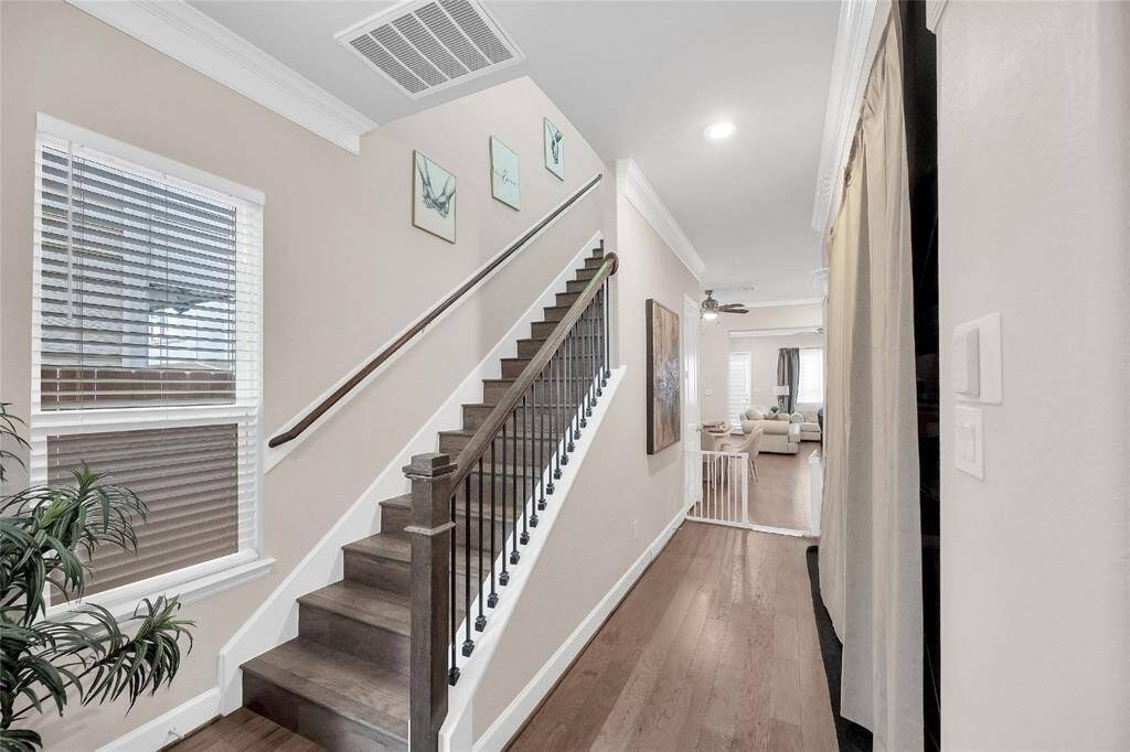 View of the kitchen and dining room beyond, tons of natural light! The stairs greet you to all three bedrooms and flex space.