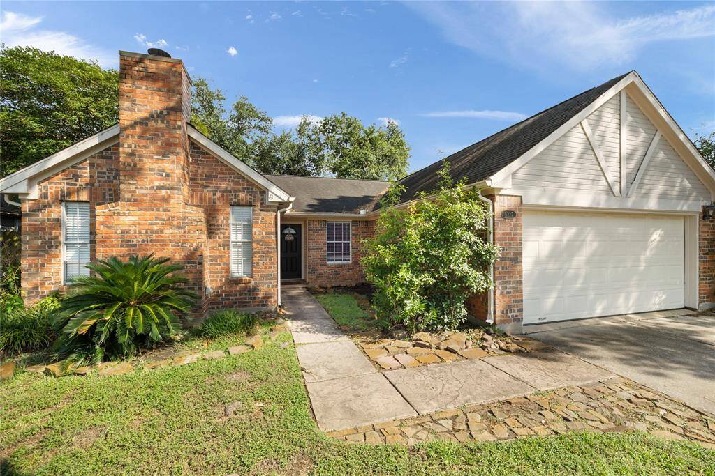Note the flagstone border along the driveway and sidewalk, adding a unique touch to the welcoming front approach.