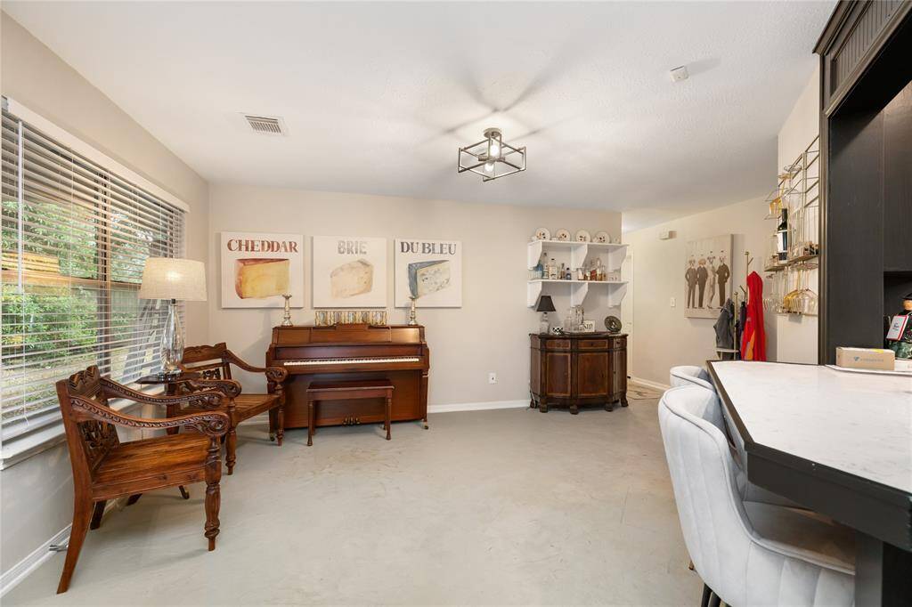 The adjacent space is filled with natural light and offers room for a buffet table or your own unique setup—ideal for everyday function or entertaining.