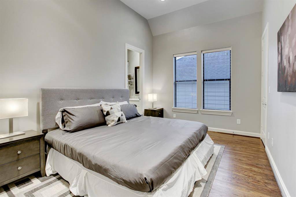 The other Guest Bedroom on the 2nd floor has a raised ceiling, a queen-sized bed and night stands, a wall-mounted TV, and easy access to a full bath shared with another guest bedroom.  This bedroom has a walk-in closet and unseen recessed lighting & a ceiling fan.