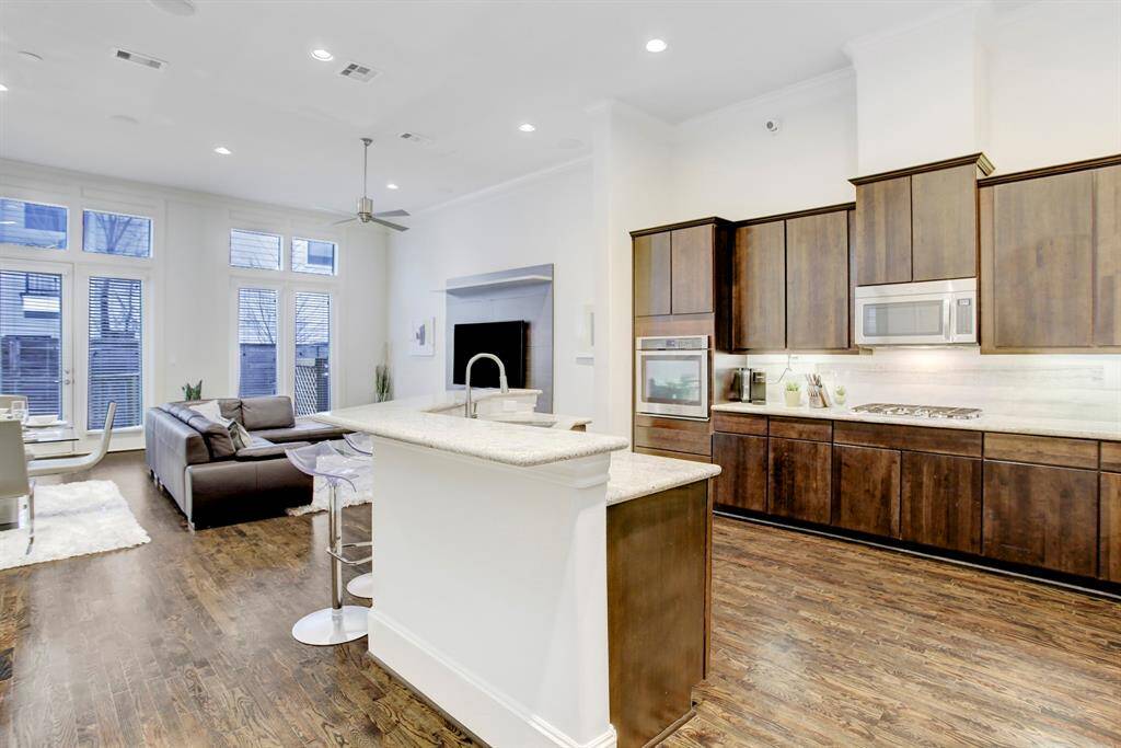 Gracious 1st floor living with sizable kitchen, breakfast bar, living area, dining space, powder bath, and easy access to garage & stairs to upper floors.