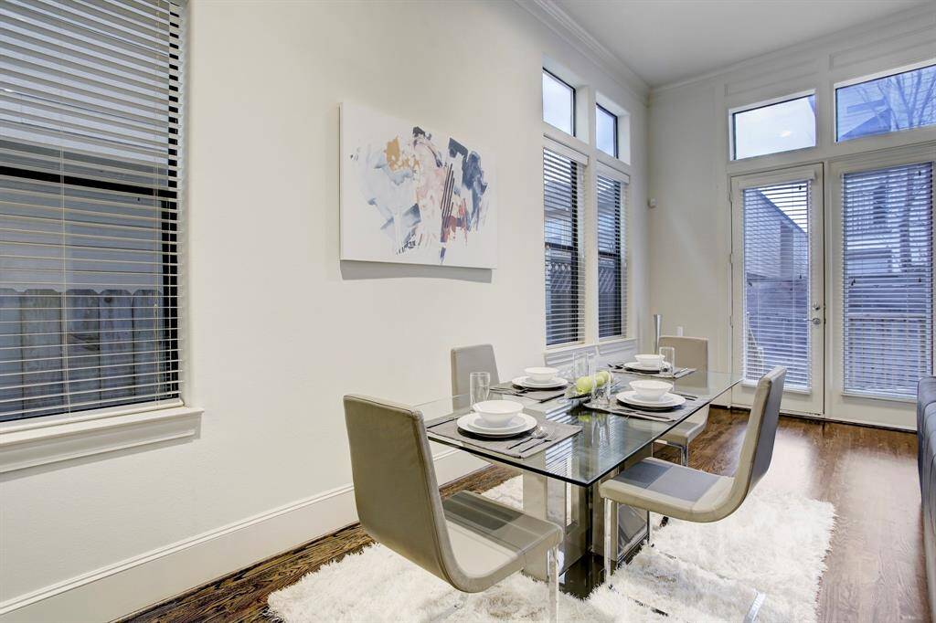 Dining area bathed in natural light.  The French doors on right open to an outdoor patio and backyard.