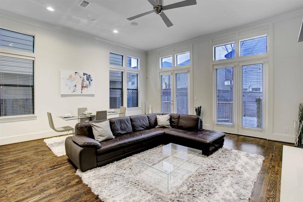 Living & Dining Areas showcase the open floorplan with 12 ft. ceilings, ceiling fan and hardwood floors.