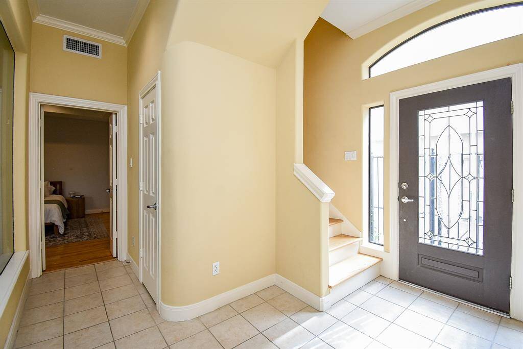 Front entry with beautiful door that lets in ample natural light.