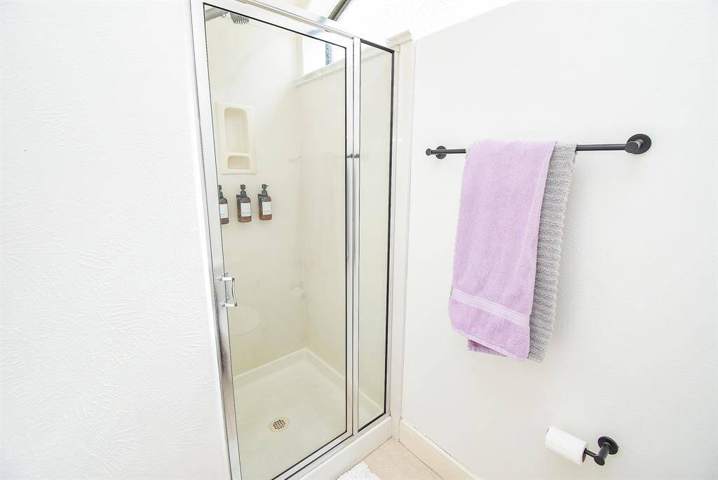 Shower with glass enclosure.