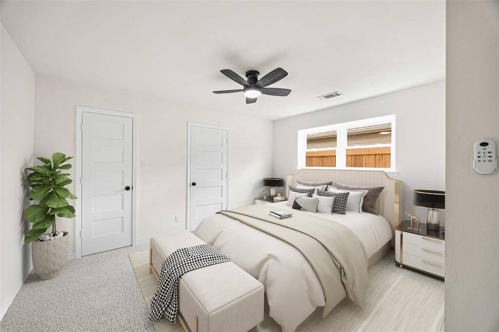 Step into the serene primary bedroom, featuring brand-new plush carpeting that adds warmth and comfort underfoot. A ceiling fan ensures a cool and inviting atmosphere, complementing the natural light streaming through well-placed windows. The en suite bathroom offers privacy and convenience, completing this thoughtfully designed retreat.