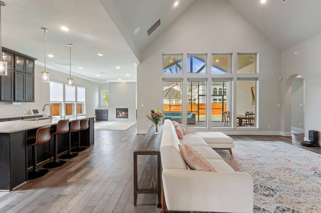 This open and airy space offers a seamless flow between the living room, dining room, and hearth room, perfect for both everyday living and entertaining!