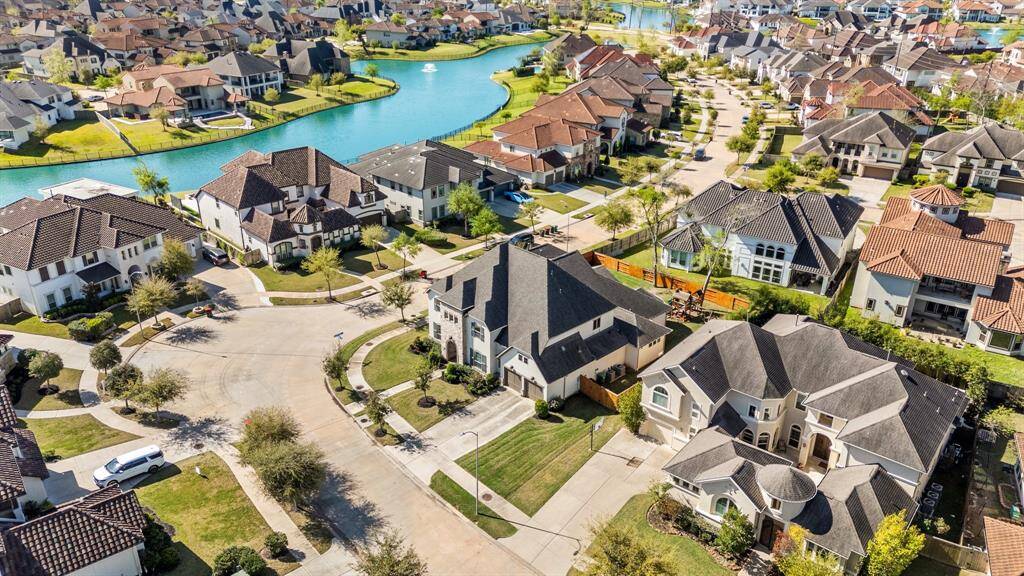 Stunning aerial view of this two-story gem in the highly desirable gated section of Avalon at Riverstone. Nestled on a peaceful corner lot, this home boasts serene views with a lake in the distance—offering the perfect blend of tranquility and convenience. A rare opportunity in an exclusive neighborhood!
