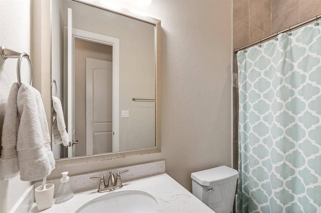 Convenient ensuite bathroom features a tub/shower combo, offering both comfort and functionality for family or guest use. Its well-designed layout provides easy access to the main floor secondary bathroom, making it a practical addition to the home.