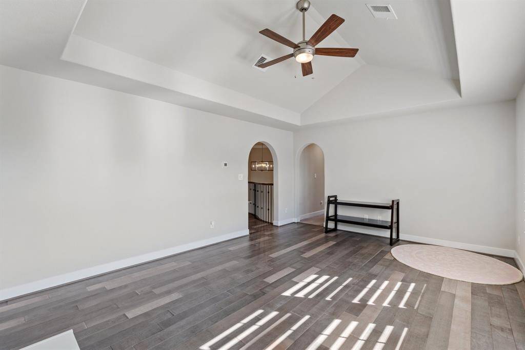 Spacious secondary living area on the second floor, designed for multi-generational living. Extended ceiling height, neutral finishes and a wall of windows provide both comfort and natural light.