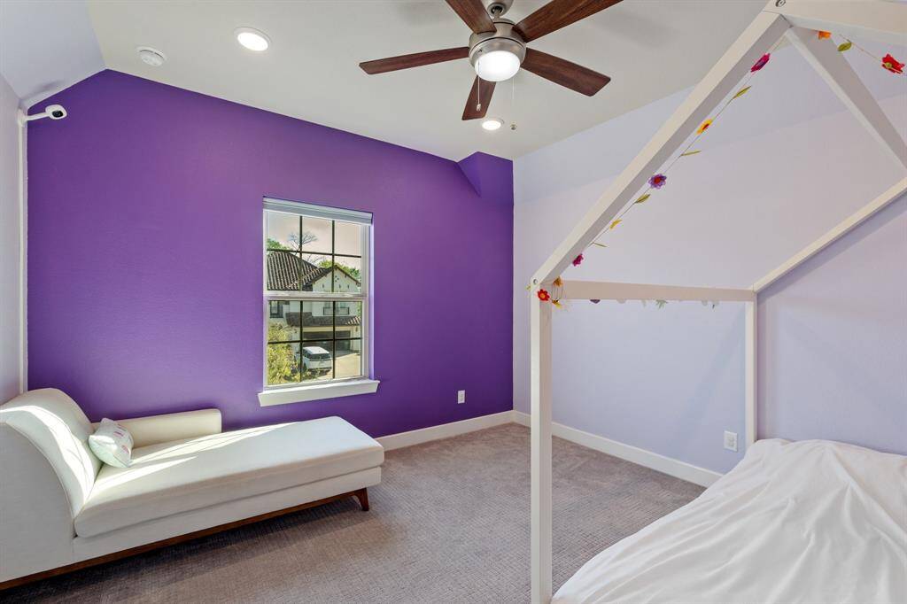 Charming secondary bedroom with an oversized window, plush carpet, and private ensuite bathroom, perfect for shared living.