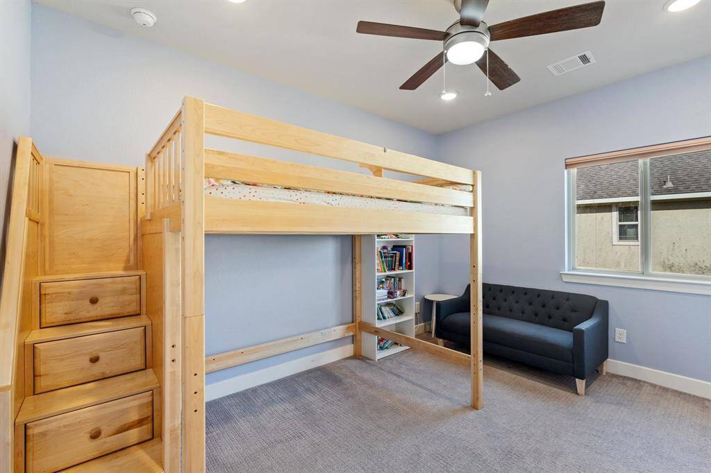 Spacious secondary bedroom featuring a walk-in closet, oversized window, and ensuite bathroom. Natural light fills the space, creating a bright and inviting atmosphere.