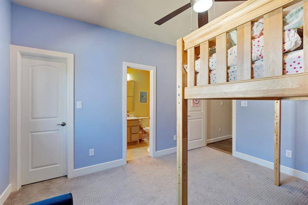 Additional view of the Spacious secondary bedroom featuring a walk-in closet, oversized window, and ensuite bathroom. Natural light fills the space, creating a bright and inviting atmosphere.