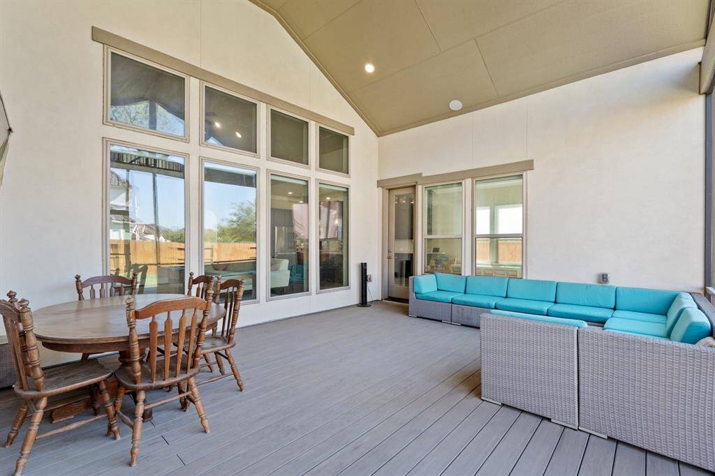 From this angle, you can truly appreciate the spaciousness of the screened-in extended covered back patio, enhanced by the high vaulted ceiling that creates an open, inviting atmosphere. It’s a seamless extension of the home, offering a private outdoor retreat!