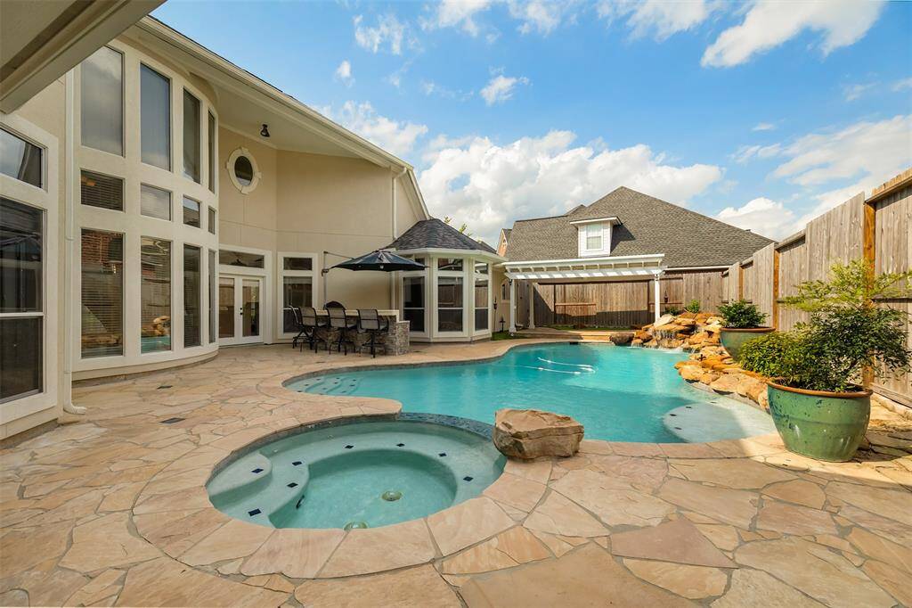 This backyard was made for Houston summers. The sparkling, heated pool with spa offers a refreshing retreat from the heat, while the spacious patio invites lounging in the shade or hosting weekend gatherings.
