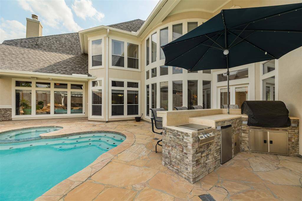 Fire up the grill in the fully equipped outdoor kitchen, updated in 2021, or gather by the fire pit beneath the pergola — this is outdoor living at its finest.