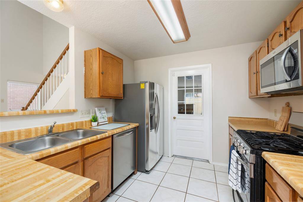 The kitchen is equipped with ample counter space and cabinetry, perfect for meal preparation and storage.