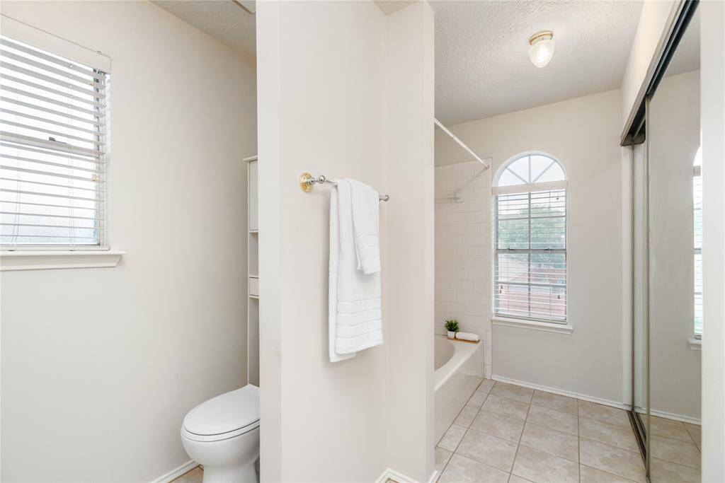 Primary bathroom has large windows that allow an abundance amount of natural light in.