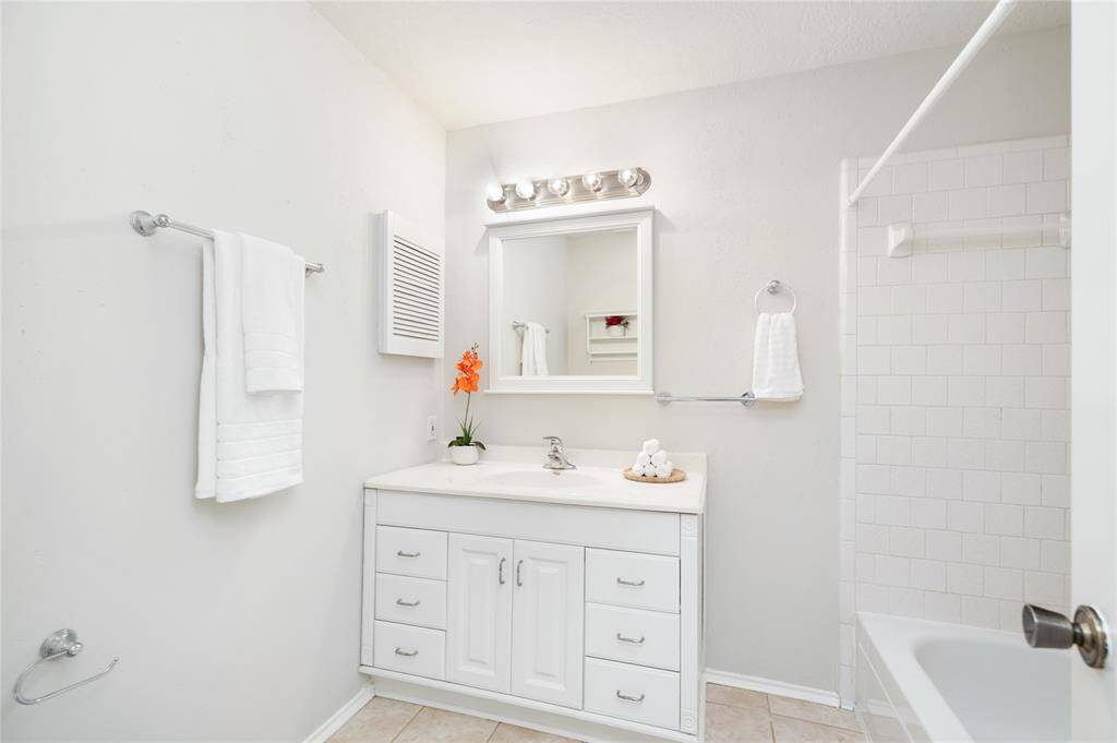 Second full bathroom has ample counter space and a tub/shower combo.