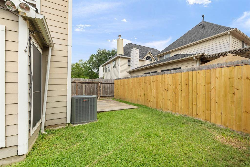 The backyard has a wooden deck, great for outdoor entertainment!