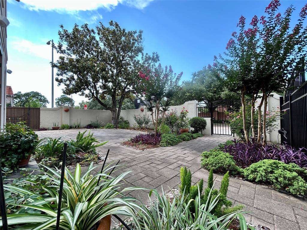 lovely gardening space all around the property with pavers walkways, patio and driveway.