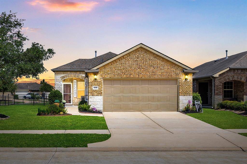 Charming single-story brick home with a extended two-car garage and welcoming front entrance.