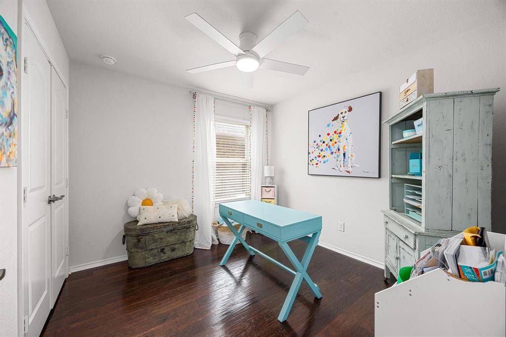 Bright and cozy secondary bedroom with wood flooring and ceiling fan with light and remote can be used as an office,