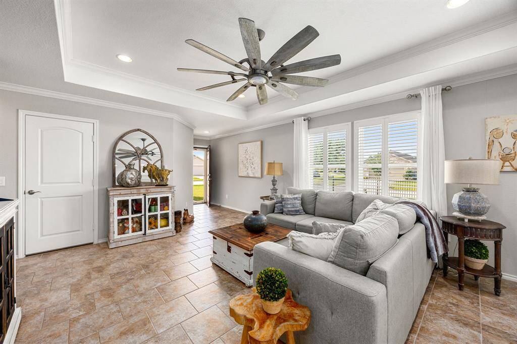 The MinkaAire 65" Farmhouse Windmill fan enhances the living area.