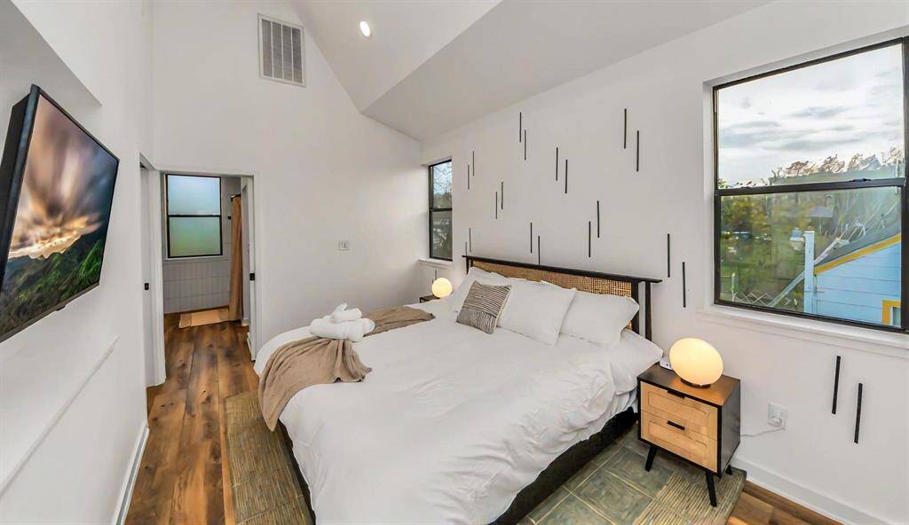 Primary suite offers engineered hardwoods, crisp white walls, and ensuite bath.