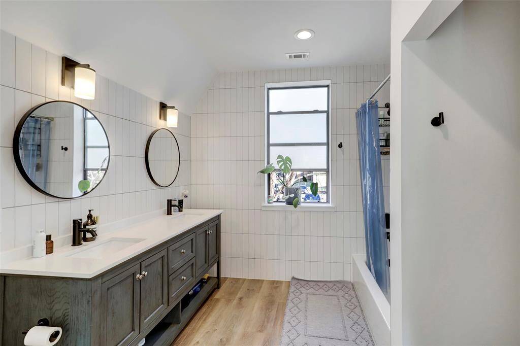 Primary bath is filled with soft modern touches. Walk-in closet is to the right.