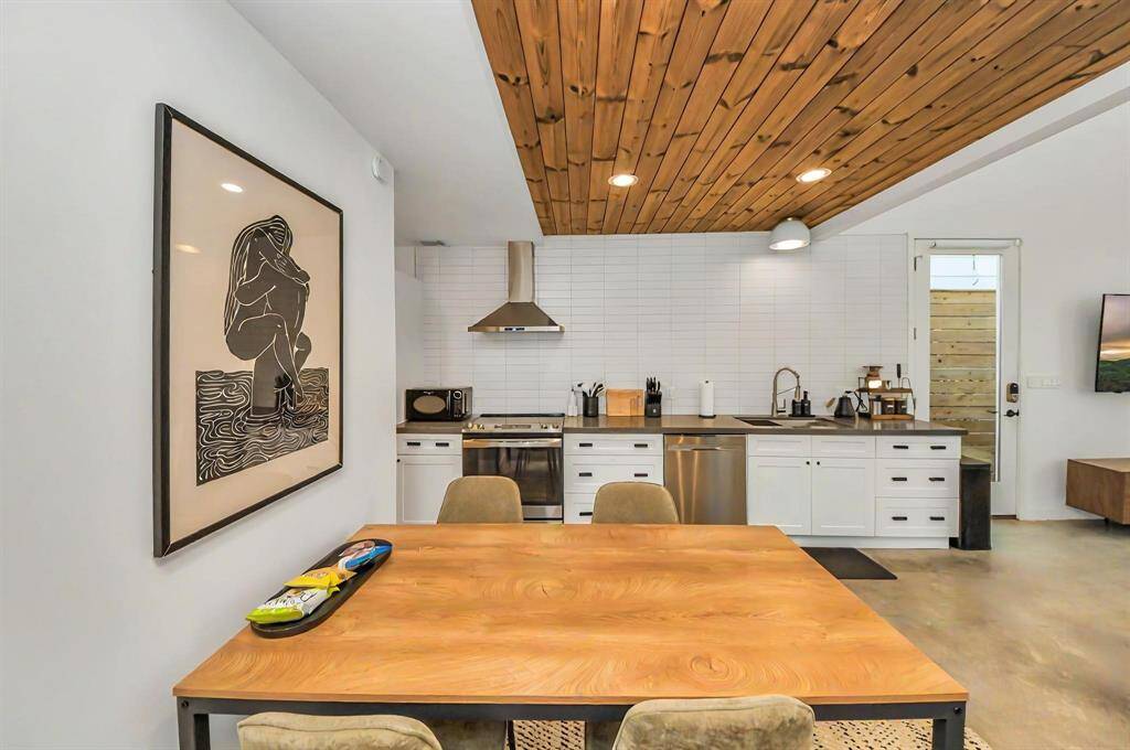 Kitchen is complete withstainless steel appliances and wood accented ceiling.