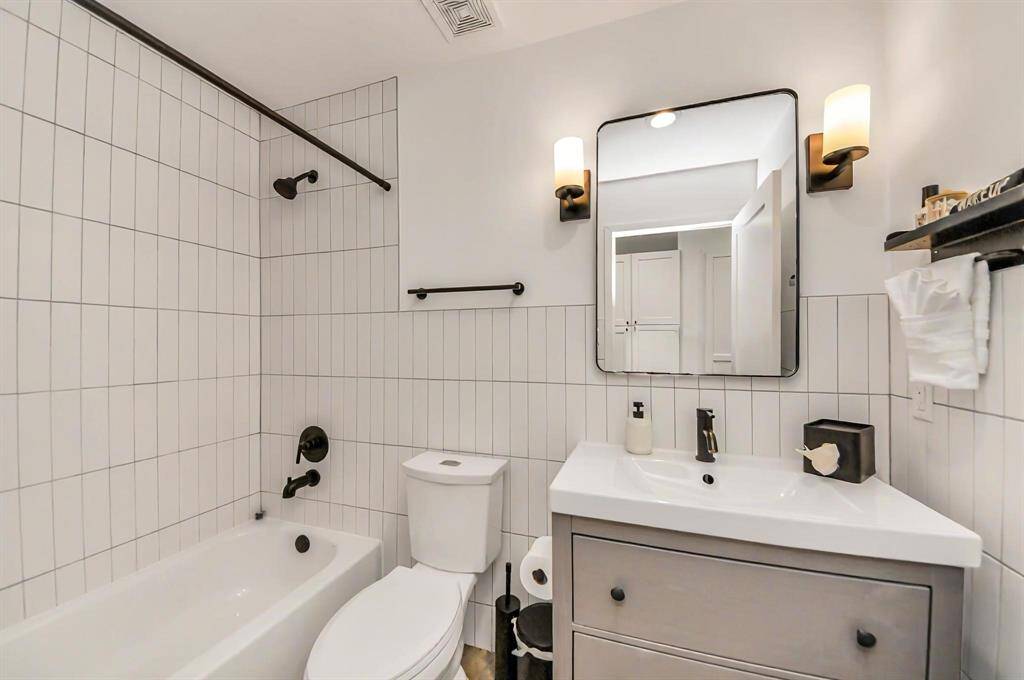 Light and bright secondary bath serves the living areas and the first floor bedroom.