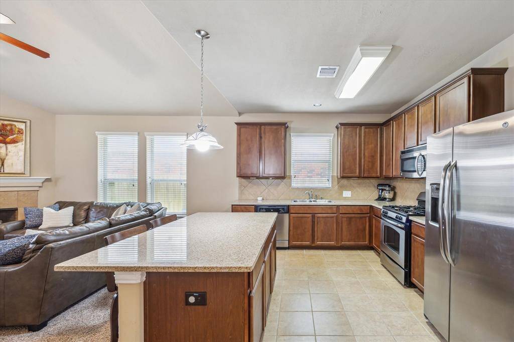 The kitchen opens seamlessly to the family room, creating a bright, connected space perfect for entertaining or everyday living. Enjoy stainless steel appliances, pendant lighting over the island, and plenty of natural light throughout.