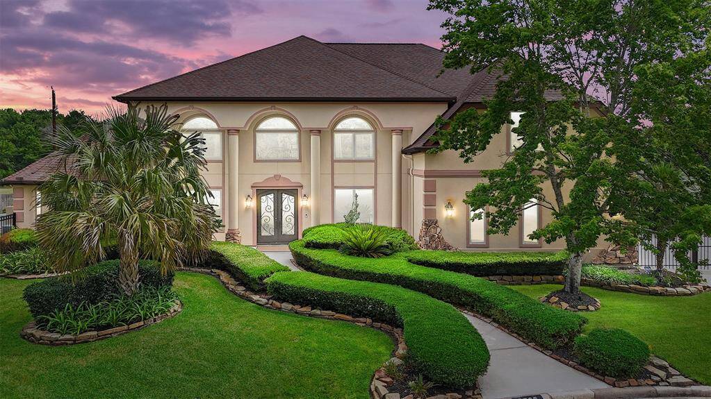 Mediterranean elegance meets timeless curb appeal. A winding sidewalk curves through the meticulously manicured lawn, guiding you to a stately entrance that sets the tone for the refined living found within.