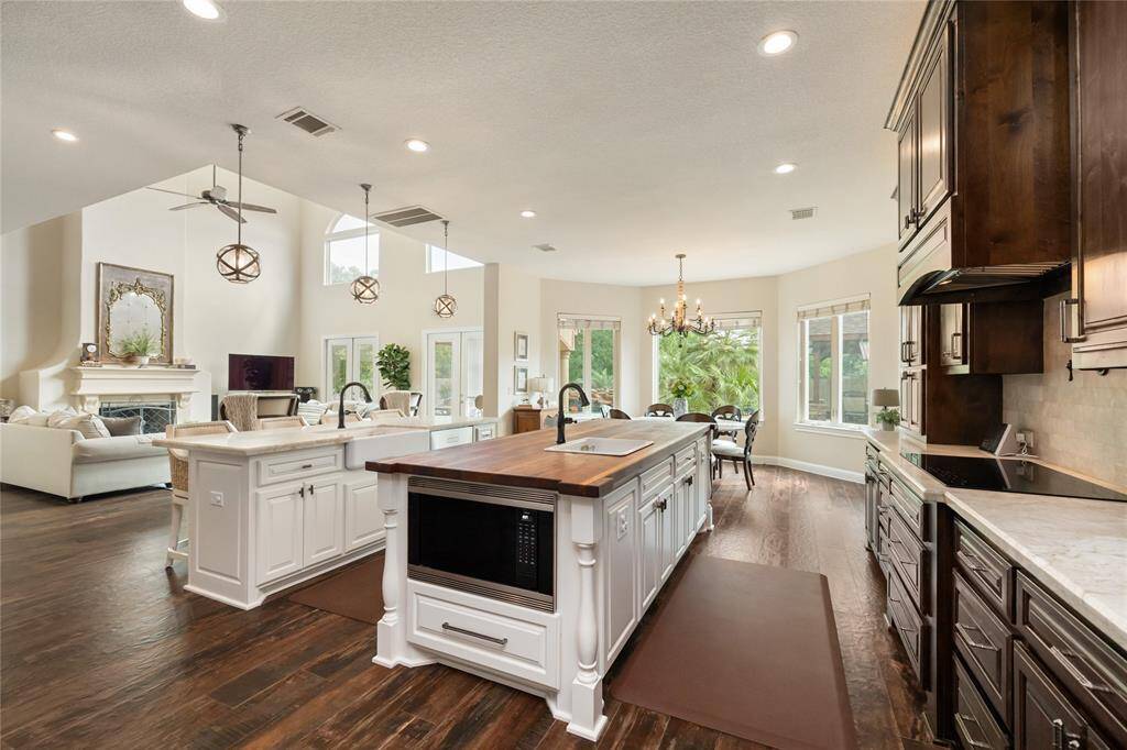 Imagine preparing meals with ease and sophistication—an electric cooktop with a pot filler above, convenient pots and pans drawers below, and a built-in microwave in the island streamline every step. Whether cooking for two or twenty, this thoughtfully designed space blends luxury and practicality seamlessly.