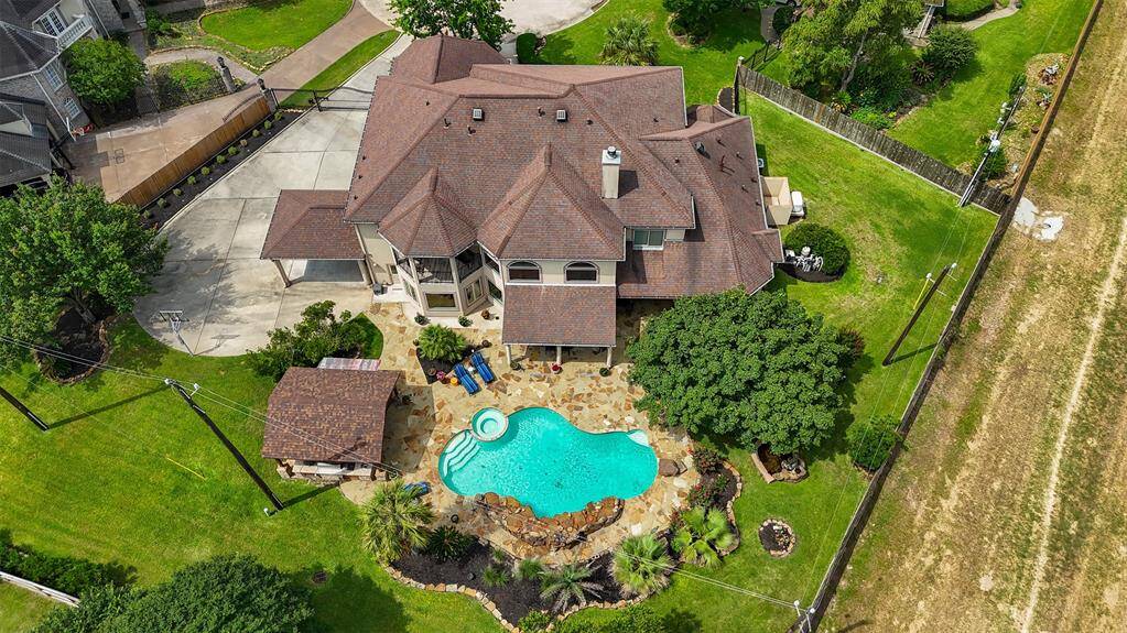 From above, the grandeur of this estate is unmistakable—lush landscaping, an impressive architectural layout, and a resort-style pool come together to form a truly captivating property.