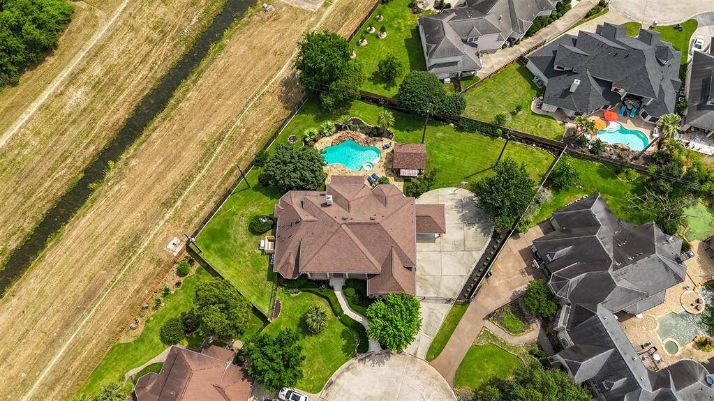From above, the estate's impressive scale and thoughtful design are on full display. With lush landscaping, striking curb appeal, and a layout tailored for both luxury and function, this home stands as a true showpiece in Wimbledon Centre Court Estates.