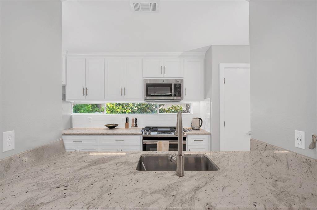 Bright kitchen with windows, bringing in lots of natural light.