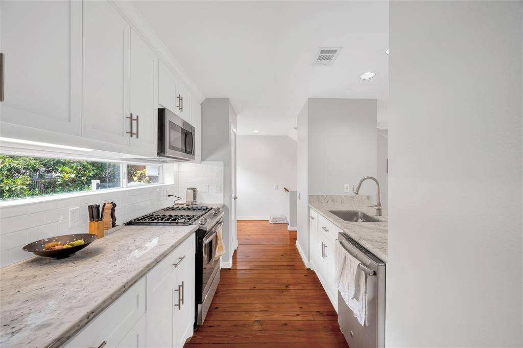 The gourmet kitchen with upgraded appliances; a chef’s dream with ample counter space and modern finishes.