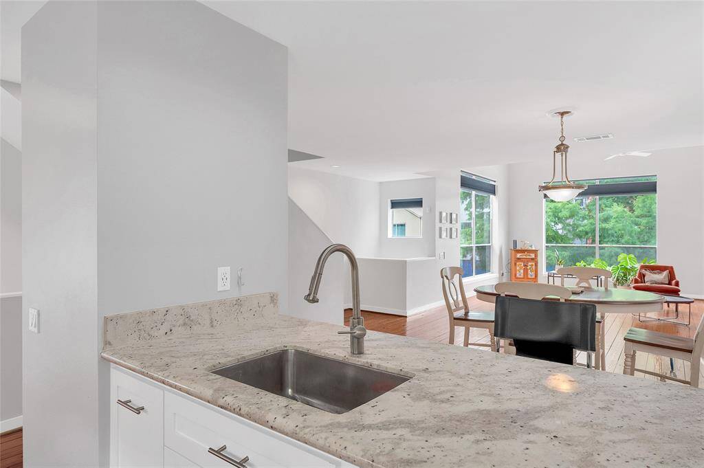 The bright and airy open concept living seamlessly connects the kitchen, dining, and living areas.