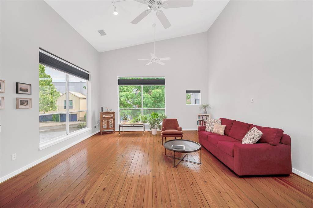 Flooded with natural light, the large windows and high ceilings make the space feel expansive. Notice the custom, remote control window treatments.