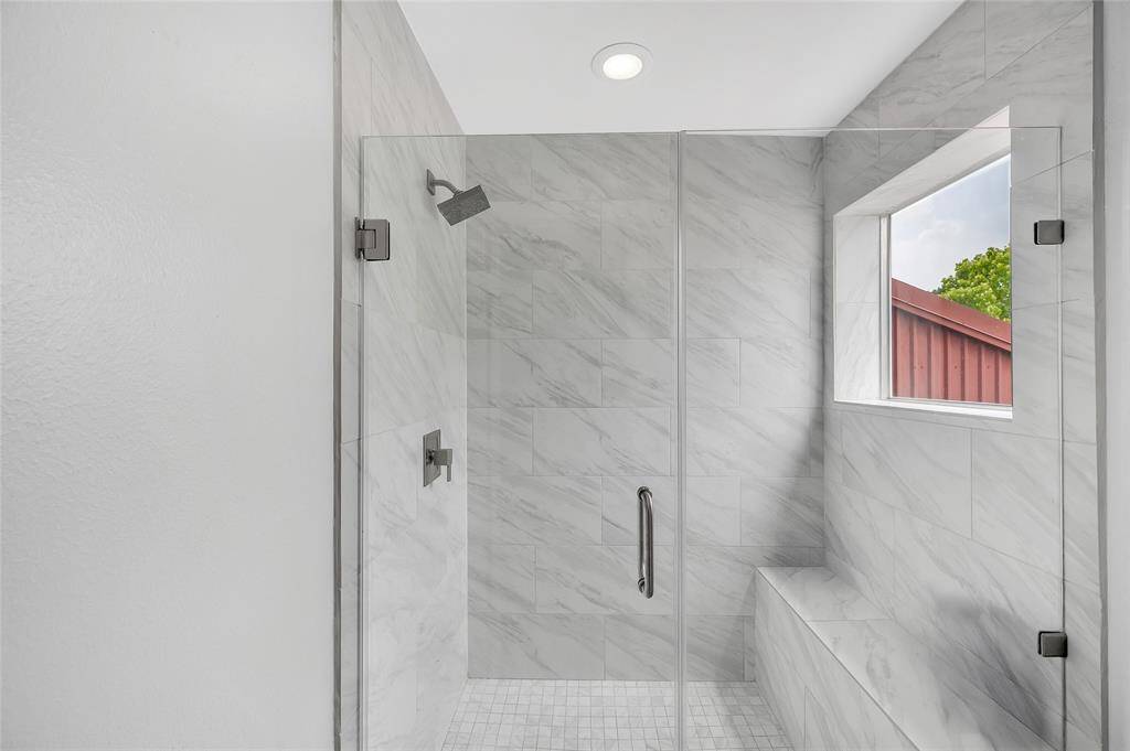 Spa-inspired walk-in shower with a tiled bench.