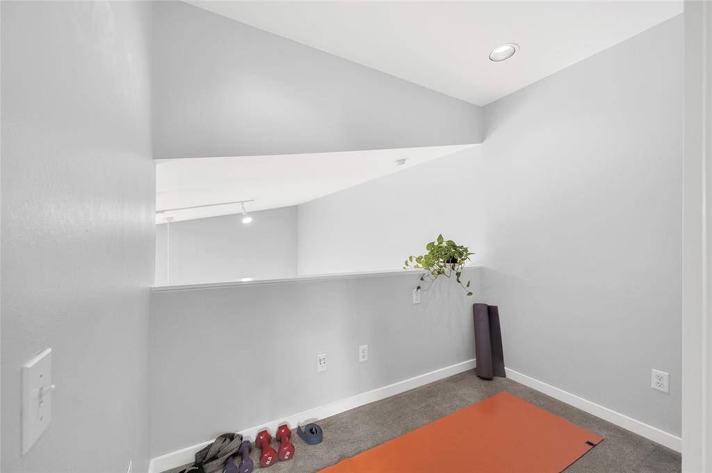 The loft/ flex room connected to the primary suite is currently used as a workout space. Would function well as a home office or for extra storage, the possibilities are endless!